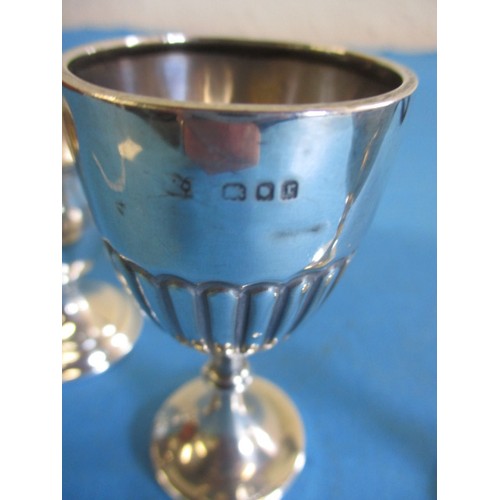 121 - Three sterling silver egg cups, various dates and makers, approx. parcel weight 69.4g, some minor de... 