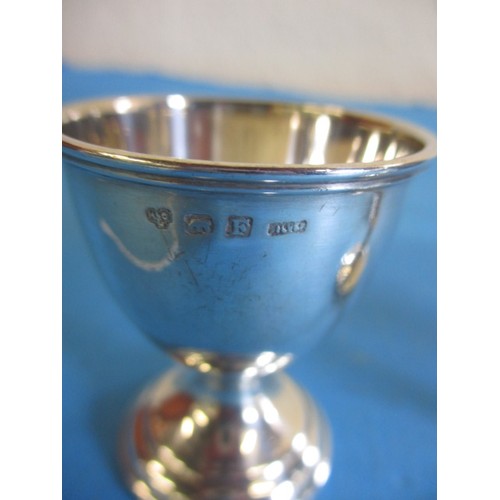 121 - Three sterling silver egg cups, various dates and makers, approx. parcel weight 69.4g, some minor de... 