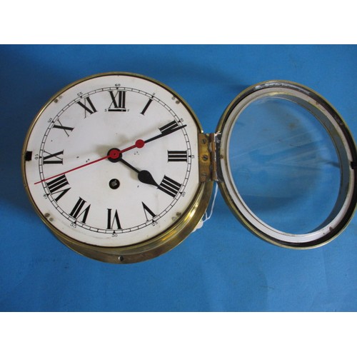 286 - An early 20th century brass and brushed steel ships style wall clock, having white enamel dial and r... 