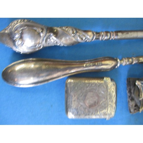 122 - A parcel of silver and silver mounted items, to include a vesta case and button hooks, all in used c... 