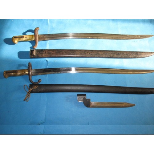 Two antique bayonets and one later example, the two 19th century examples have scabbards, all in good condition with use related marks