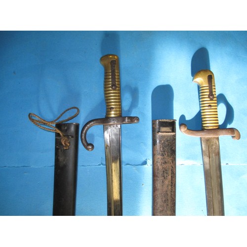 206 - Two antique bayonets and one later example, the two 19th century examples have scabbards, all in goo... 