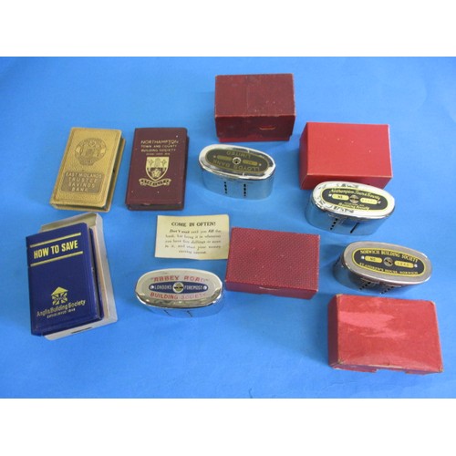 238 - A parcel of vintage bank and building society money boxes, some with original packaging box