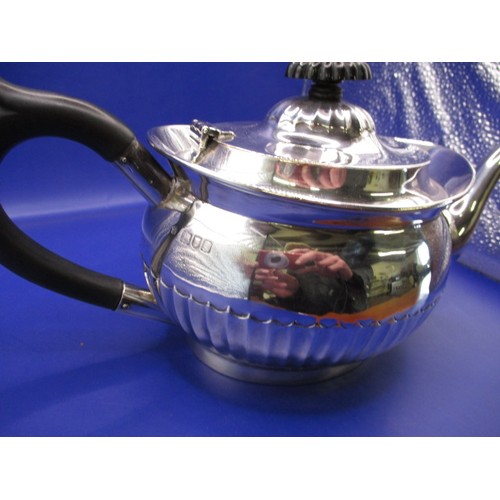 128 - An antique sterling silver and ebony handled teapot, London hallmark. In good used condition, with a... 