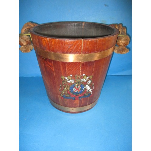 318 - A vintage teak bucket with copper and brass mounts with decorative crest to front, in good pre-owned... 