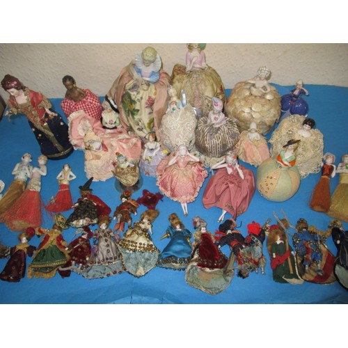 255 - A collection of antique and later porcelain half dolls, some made in to pin cushions and some in to ... 