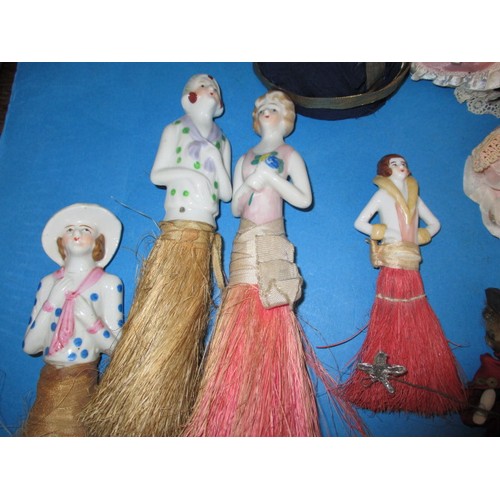 255 - A collection of antique and later porcelain half dolls, some made in to pin cushions and some in to ... 