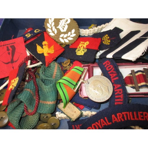 161 - A parcel of very interesting collectables, to include military metal and cloth badges, an Egyptian g... 