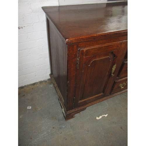 313 - A Georgian oak sideboard with 3 central drawers flanked with cupboards. Dating C mid/late 18th centu... 