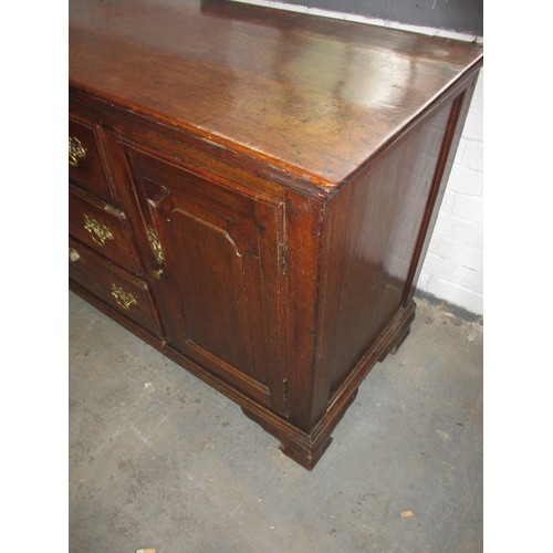 313 - A Georgian oak sideboard with 3 central drawers flanked with cupboards. Dating C mid/late 18th centu... 