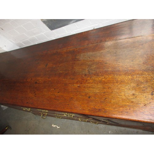 313 - A Georgian oak sideboard with 3 central drawers flanked with cupboards. Dating C mid/late 18th centu... 