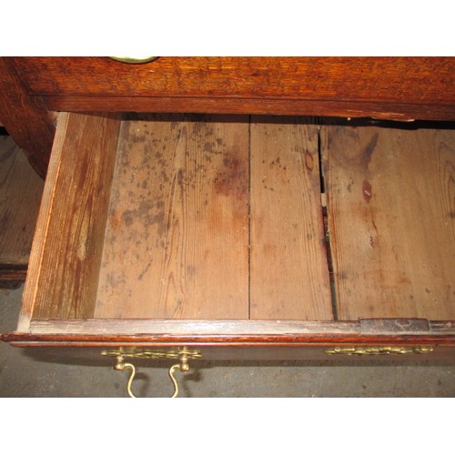 313 - A Georgian oak sideboard with 3 central drawers flanked with cupboards. Dating C mid/late 18th centu... 