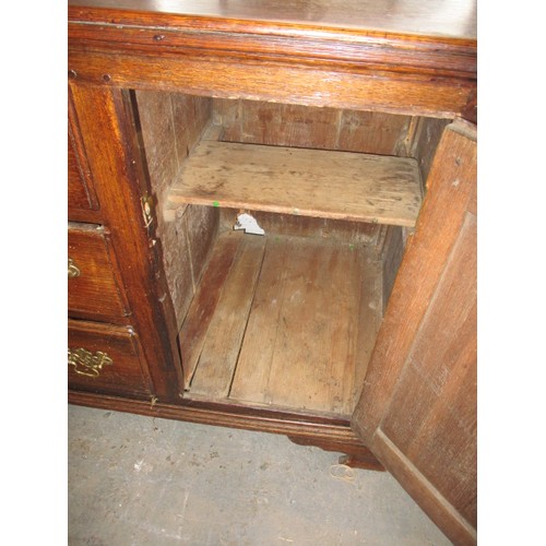 313 - A Georgian oak sideboard with 3 central drawers flanked with cupboards. Dating C mid/late 18th centu... 