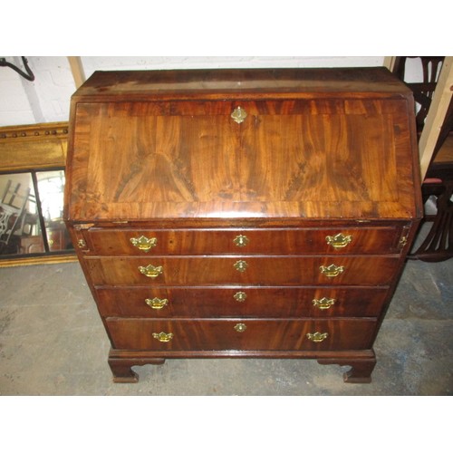 316 - A 19thC Mahogany bureau having 4 long graduated drawers and fold over writing flap, revealing drawer... 