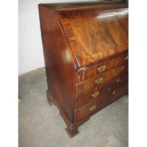 316 - A 19thC Mahogany bureau having 4 long graduated drawers and fold over writing flap, revealing drawer... 