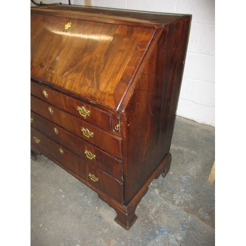 316 - A 19thC Mahogany bureau having 4 long graduated drawers and fold over writing flap, revealing drawer... 