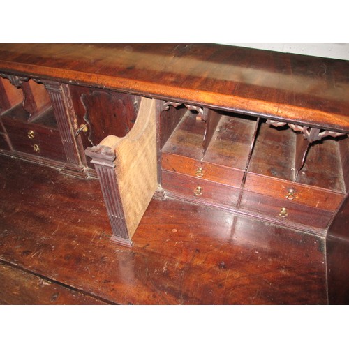 316 - A 19thC Mahogany bureau having 4 long graduated drawers and fold over writing flap, revealing drawer... 