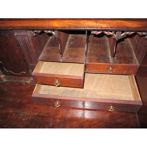 316 - A 19thC Mahogany bureau having 4 long graduated drawers and fold over writing flap, revealing drawer... 