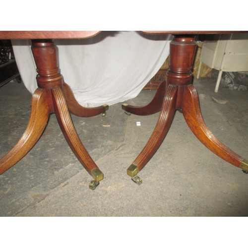 311 - An antique mahogany 2 part pedestal dining table on splayed sabre legs, each part with tipping top, ... 