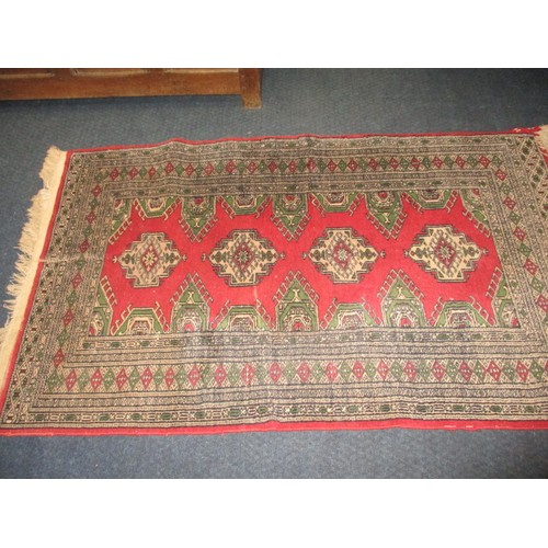 276 - A vintage Persian wool rug having a red ground with geometric pattern, approx. size 155cm x 94cm in ... 