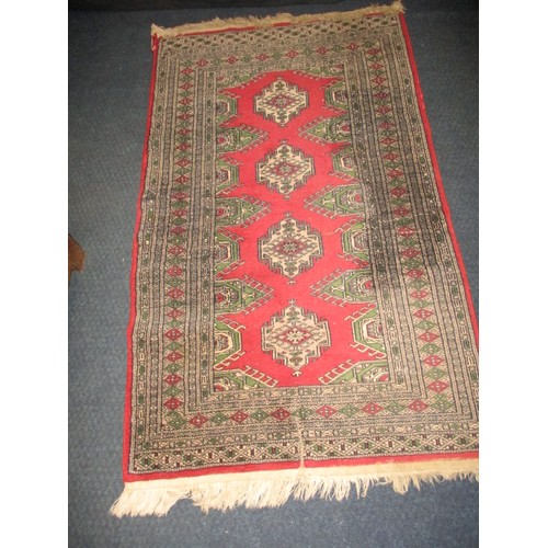 276 - A vintage Persian wool rug having a red ground with geometric pattern, approx. size 155cm x 94cm in ... 