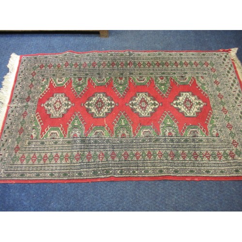 276 - A vintage Persian wool rug having a red ground with geometric pattern, approx. size 155cm x 94cm in ... 