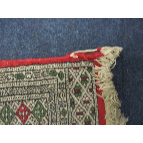 276 - A vintage Persian wool rug having a red ground with geometric pattern, approx. size 155cm x 94cm in ... 