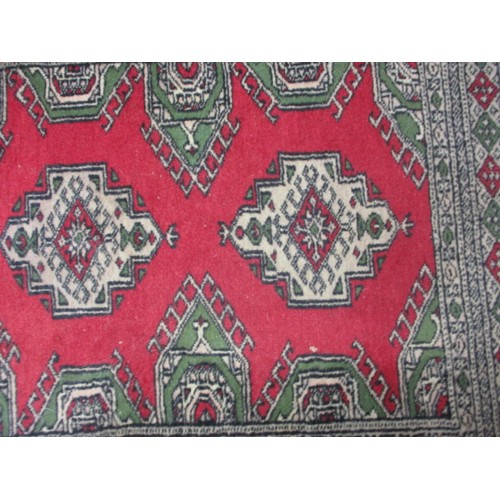 276 - A vintage Persian wool rug having a red ground with geometric pattern, approx. size 155cm x 94cm in ... 