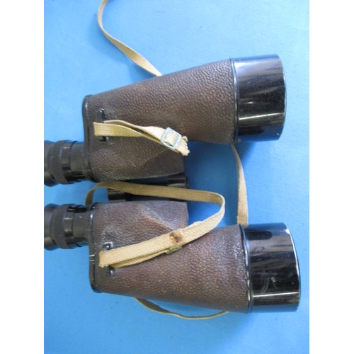 214 - A pair of US navy binoculars marked Bausch & Lomb and two brass compasses, one dated 1904, in used c... 