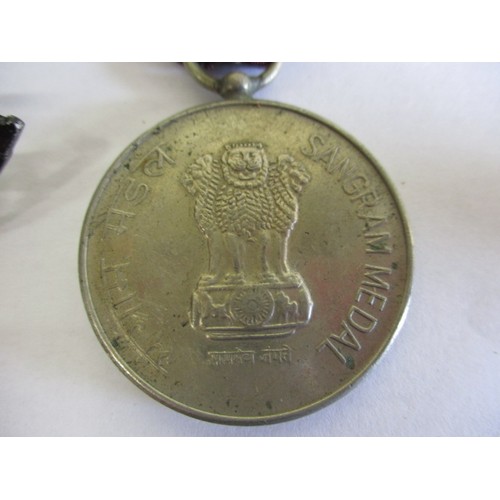 206 - A medal and badges from an Indian regiment, in good used condition