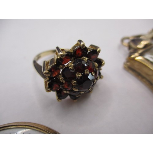 7 - A 9ct yellow gold and garnet dress ring, a 9ct gold cased cocktail watch and a yellow metal cased fo... 