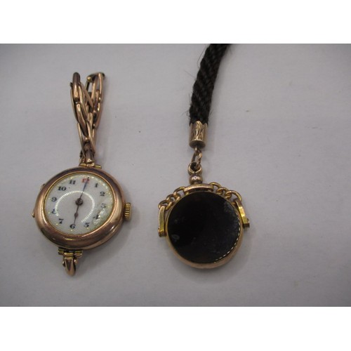 98 - A 9ct gold cased wrist watch marked Rolex to inside and a 9ct hard stone fob, watch has crack to dia... 