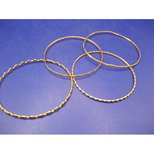 81 - 4 Asian yellow metal bangles, all un-marked but acid tested as gold, approx. parcel weight 33.9g