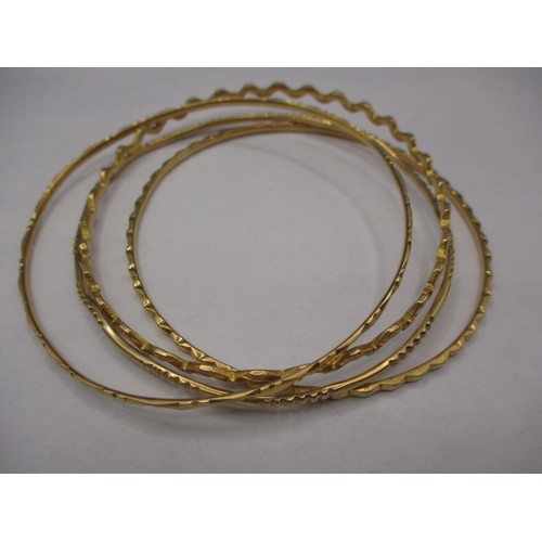 81 - 4 Asian yellow metal bangles, all un-marked but acid tested as gold, approx. parcel weight 33.9g