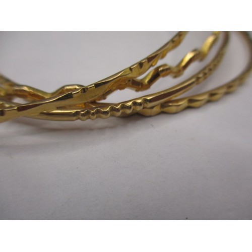 81 - 4 Asian yellow metal bangles, all un-marked but acid tested as gold, approx. parcel weight 33.9g