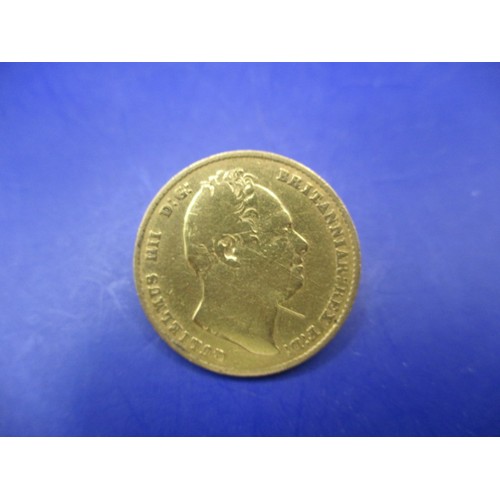 121 - A William IIII 1832 shield back full gold sovereign, a circulated coin with associated use marks