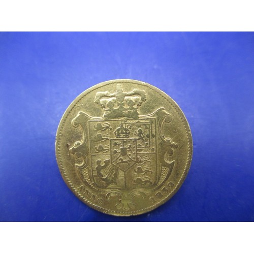 121 - A William IIII 1832 shield back full gold sovereign, a circulated coin with associated use marks