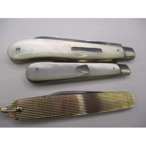 117 - Three vintage penknives, two antique with MOP and silver blades the other yellow metal example marke... 