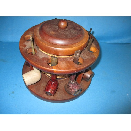 362 - A vintage circular pipe rack with central tobacco jar, pipes include examples by Dunhill and Peterso... 