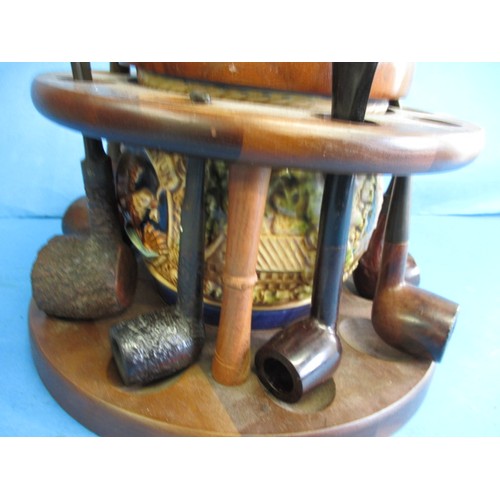 362 - A vintage circular pipe rack with central tobacco jar, pipes include examples by Dunhill and Peterso... 