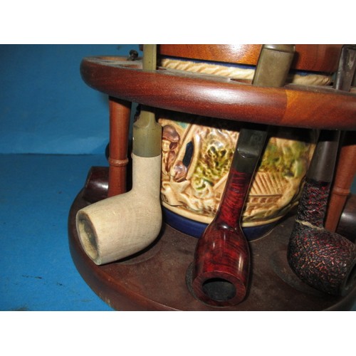 362 - A vintage circular pipe rack with central tobacco jar, pipes include examples by Dunhill and Peterso... 