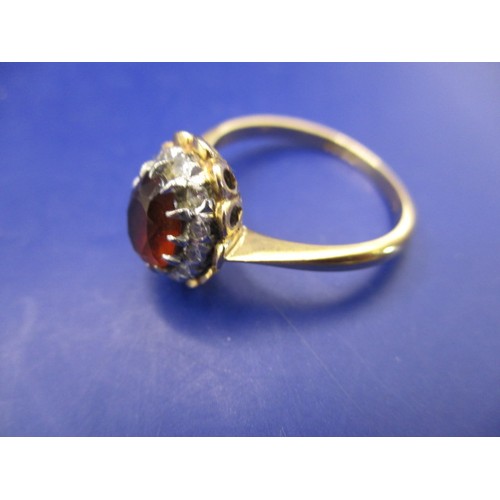 42 - A vintage 18ct gold cluster ring with central garnet surrounded by small diamonds, approx. ring size... 