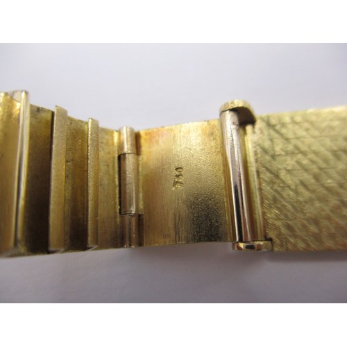 103 - A vintage 18ct gold cased gents dress watch with integral gold strap, the dial and movement marked O... 