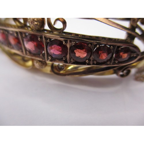 89 - An antique 9ct gold bangle set with a central band of rubies, approx. weight 9.6g in good pre-owned ... 