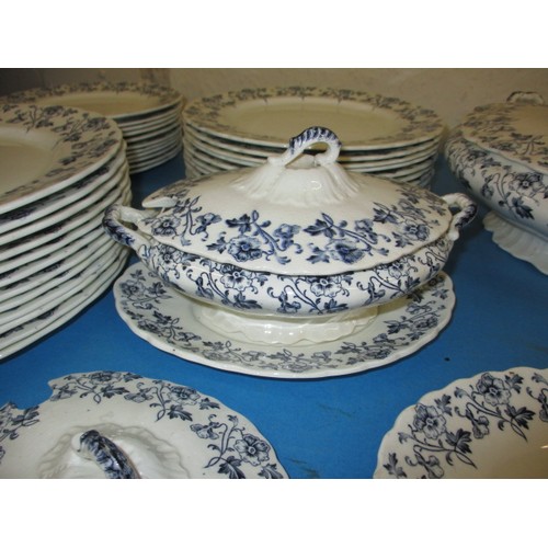 12 - A vintage Staffordshire dinner service in the Ascot design by W Hulme, in used condition with glaze ... 