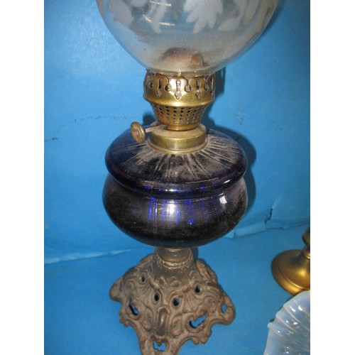 61 - Two early 20th century oil lamps and a Vaseline glass shade, in good used condition with age-related... 