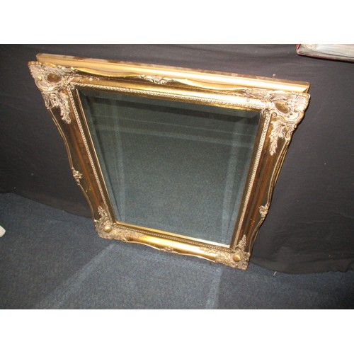 64 - A gilt framed bevelled glass wall mirror, approx. size   75x60cm in good pre-owned condition