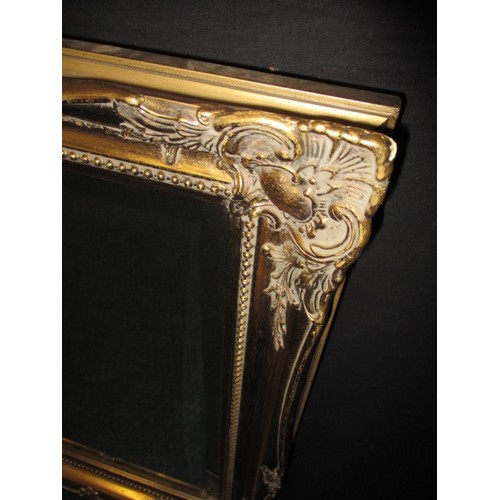 64 - A gilt framed bevelled glass wall mirror, approx. size   75x60cm in good pre-owned condition