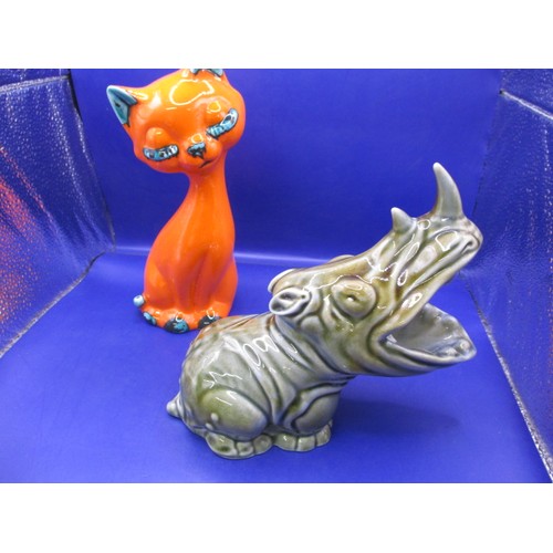 68 - An Irish porcelain rhinoceros and an orange glazed cat figure, both in good pre-owned condition with... 