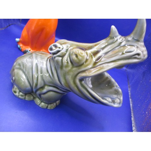 68 - An Irish porcelain rhinoceros and an orange glazed cat figure, both in good pre-owned condition with... 